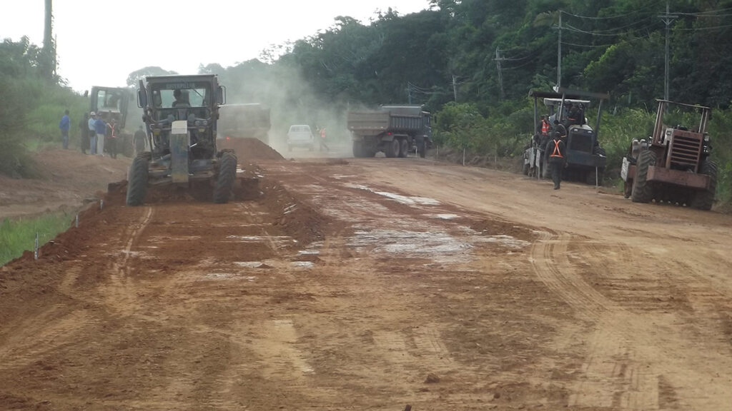 Earthmoving machinery works on a dusty portion at kilometer 667 of Highway BR-319 in the state of Amazonas.