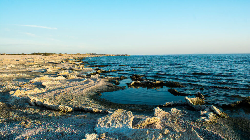 A white shoreline with coarse sand.