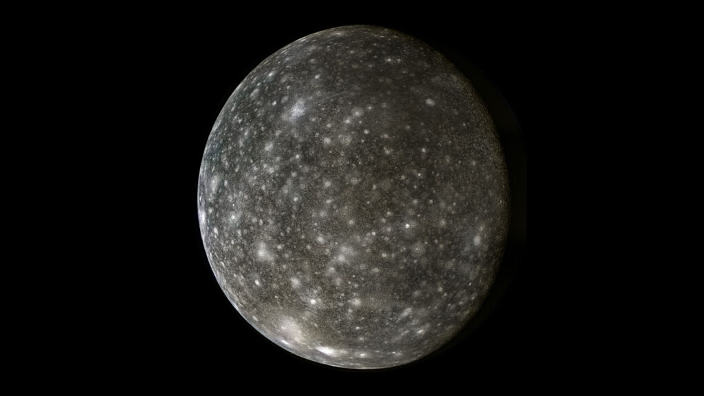 A smooth, spherical shape appears against a black background, its dark gray surface covered in many overlapping lighter gray and white circular shapes of varying shades and sizes.
