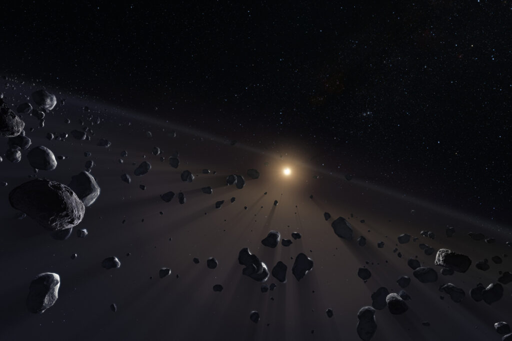 Bright rays spray off small dark bodies with a bright star in the background.