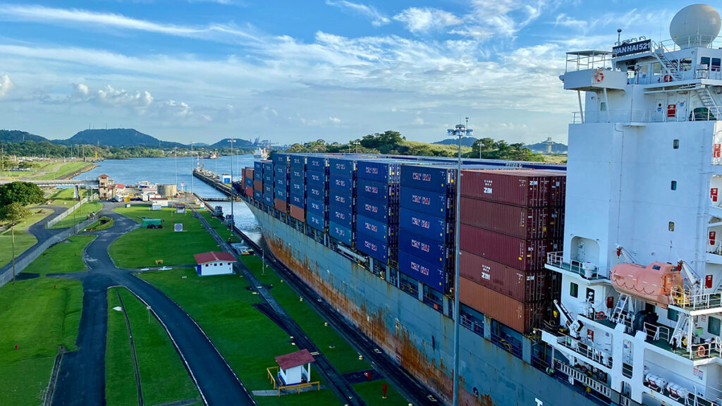 A container ship in a narrow channel of water