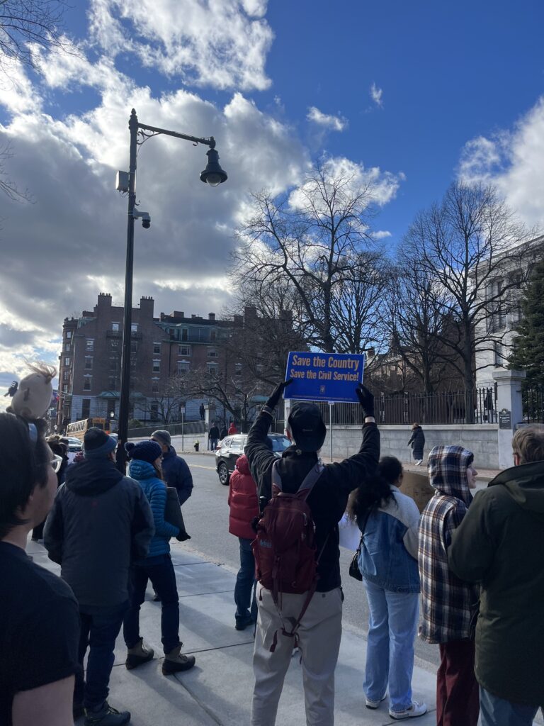 Rally attendees hold signs in support of science.