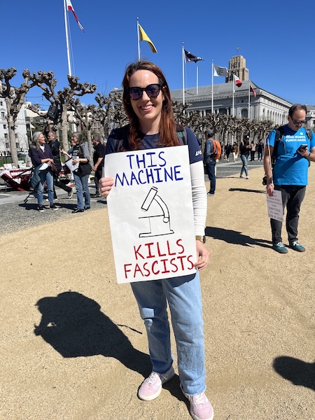 Protest sign: This machine kills fascists (the machine being a microscope)