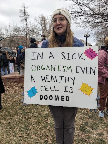 Protest sign: In a sick organism, even a healthy cell is doomed