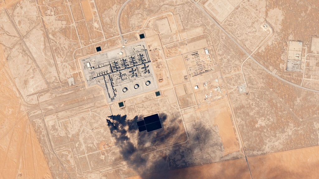 A satellite image of the Khurais Oil Field in Saudi Arabia taken in February 2017 shows the industrial facility in the desert, releasing two dark black plumes of smoke.