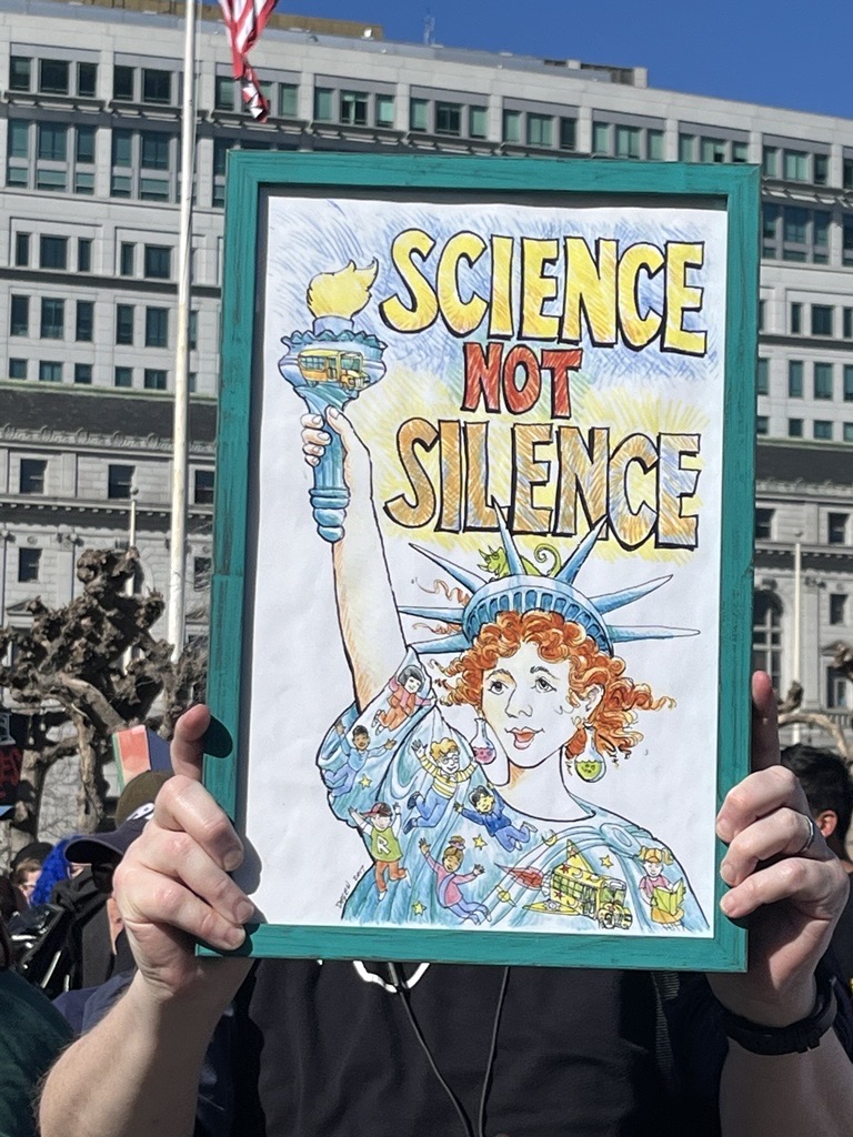A drawing of the Statue of Liberty with the words "science not silence."