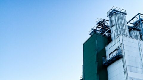 An industrial building against a blue sky.