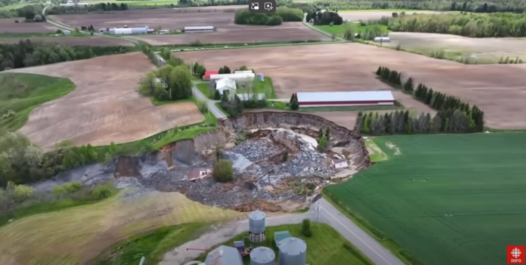 A drone image of the site of the 21 May 2025 quick clay landslide at Sainte Monique in Canada. Still from a drobe video posted to Youtube by Radio-Canada Info.