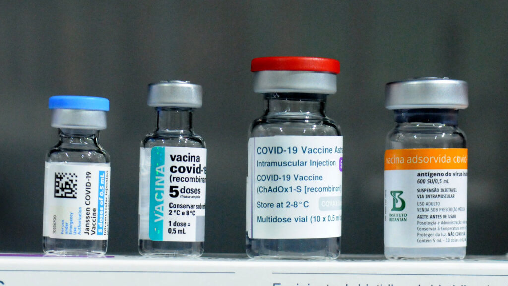 Four bottles of the COVID-19 vaccine sit in a row.