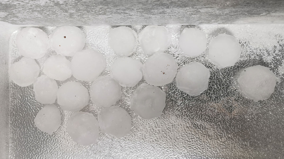 A silver cooler with 20 round hailstones