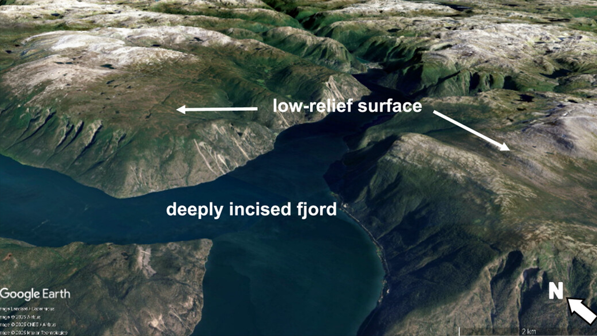 Google Earth image of a mountainous region with a deeply incised fjord and low relief surfaces surrounding.