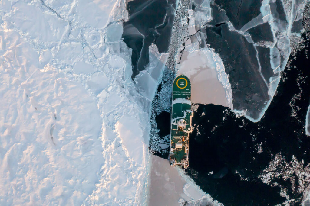 Overhead view of the breaker R/V Kronprins Haakon sailing amid sea ice in the Arctic Ocean.