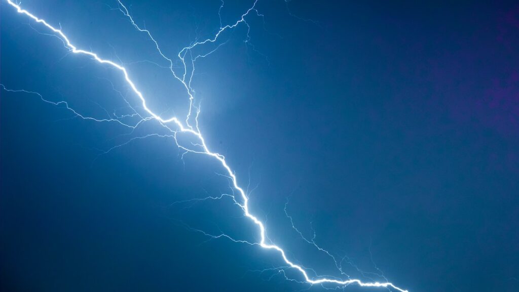 A bolt of lightning against a dark blue sky.