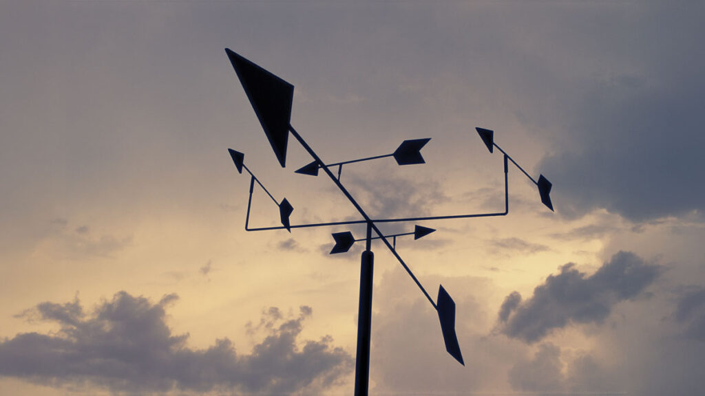 Weather vane in the clouds