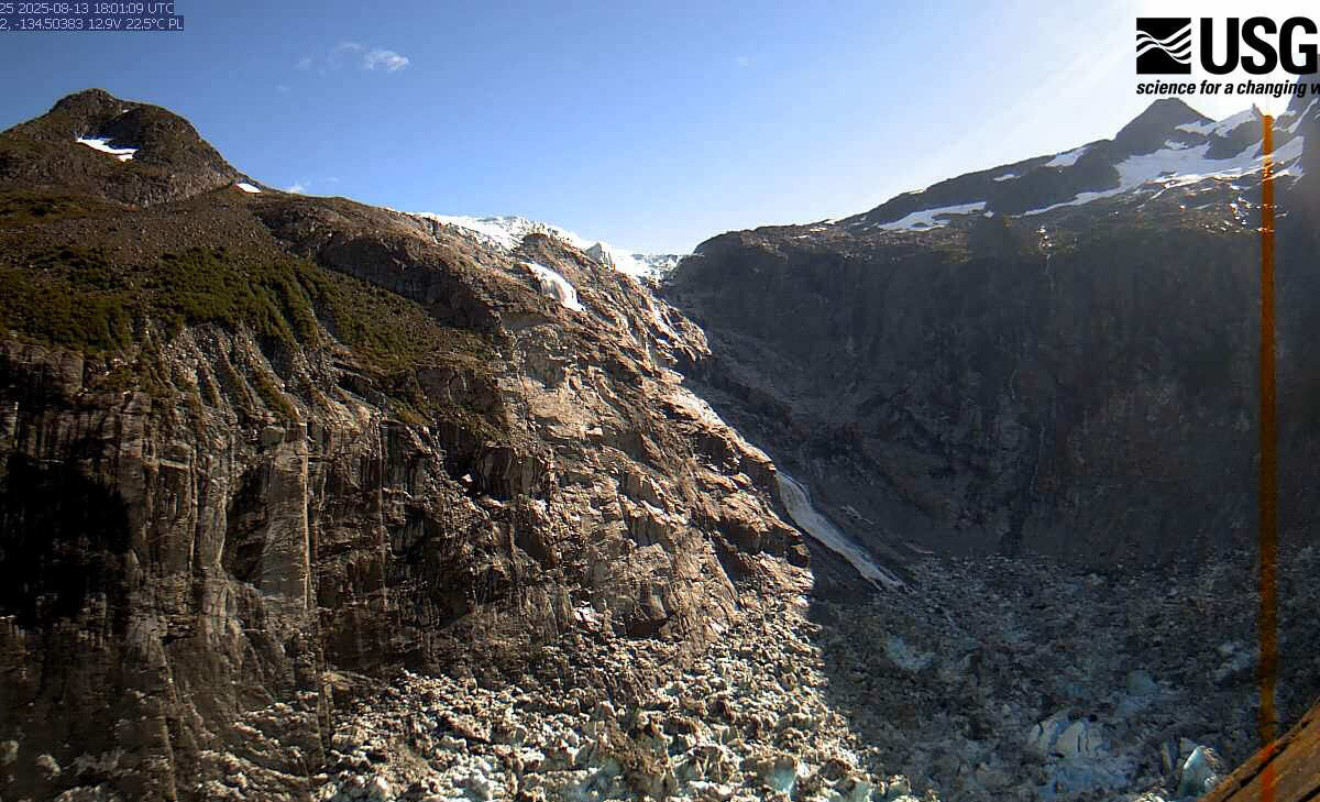 A rock basin with snow on its edges has recently been emptied of water.