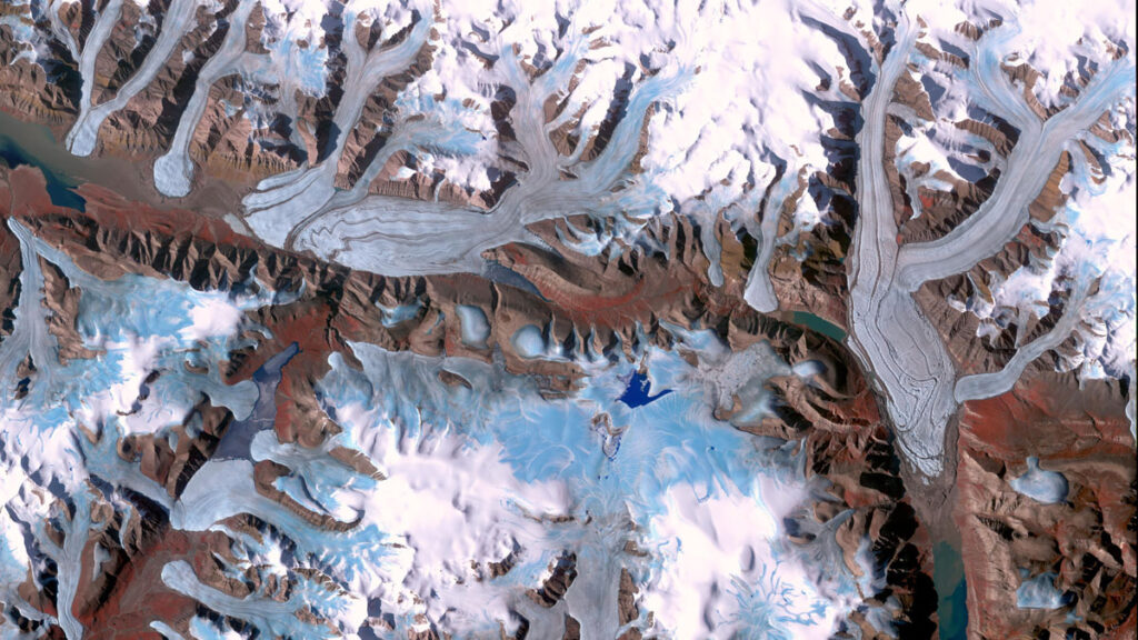 Satellite view of many glaciers covering portions of a mountainous landscape.