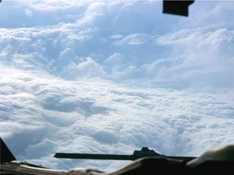 Clouds seen from the window of a plane. The plane is in the eye of a storm.