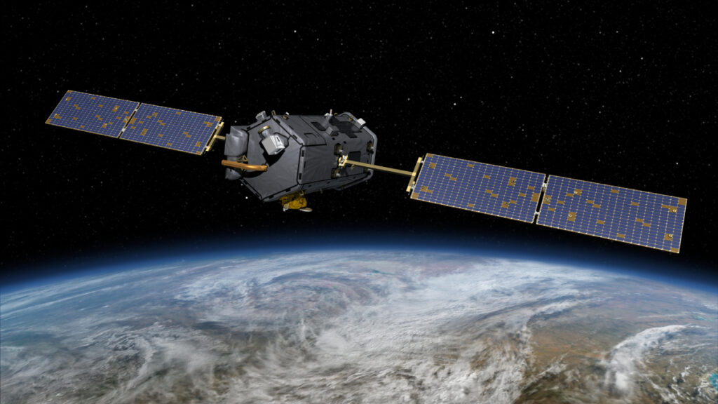 Illustration of a hexagonal satellite with two large solar panels orbiting above a cloudy Earth.