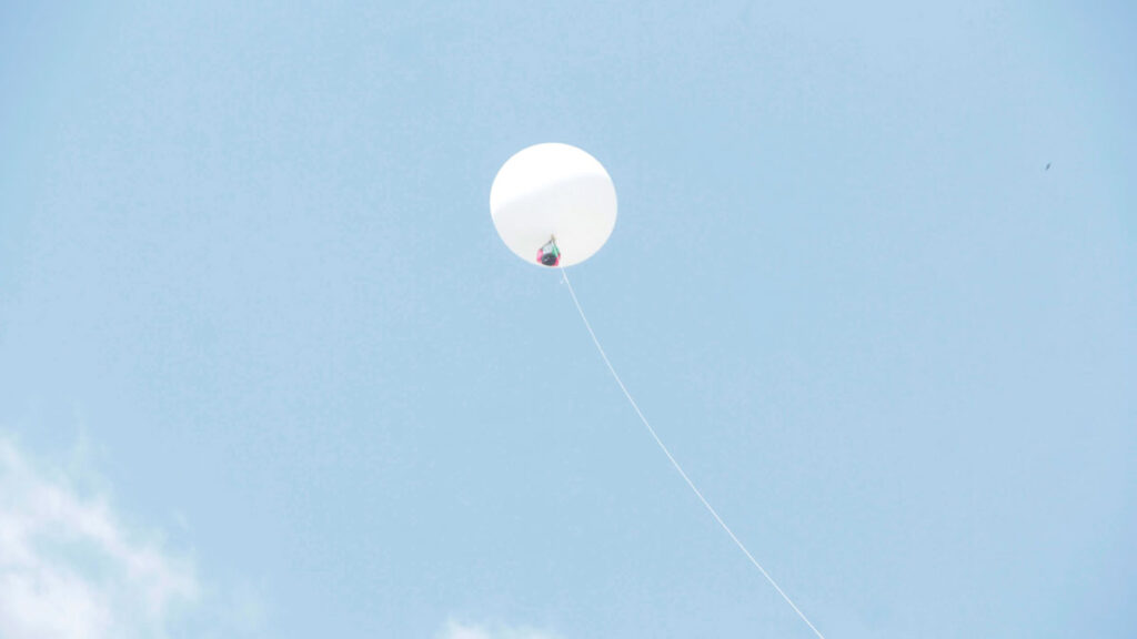 An atmospheric balloon lofts into the air a CubeSat prototype built by Ghanaian students.