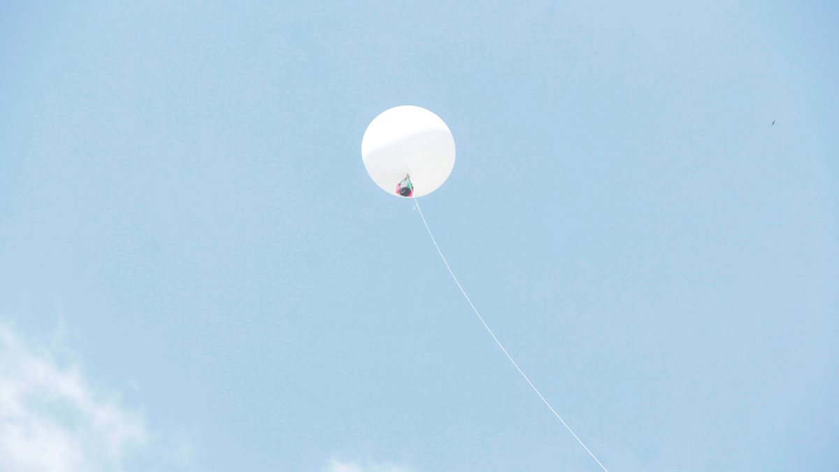 An atmospheric balloon lofts into the air a CubeSat prototype built by Ghanaian students.