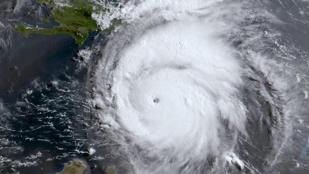 A hurricane rotates over the Caribbean Sea in a satellite image.