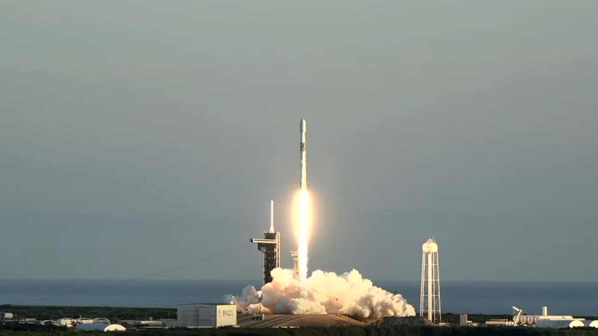 A rocket launches in front of a clear sky