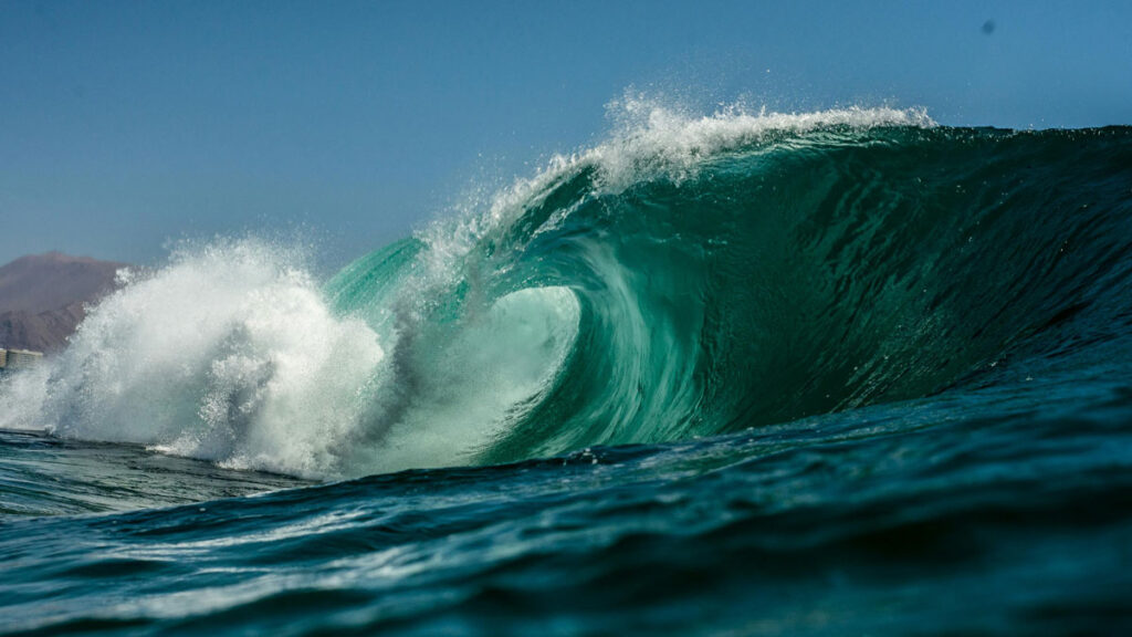 Close-up image of a turquoise breaking wave