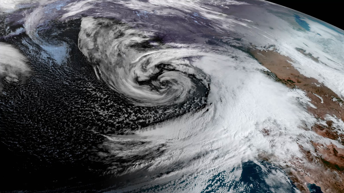 A satellite image shows a swirl of clouds off the western coast of the United States.