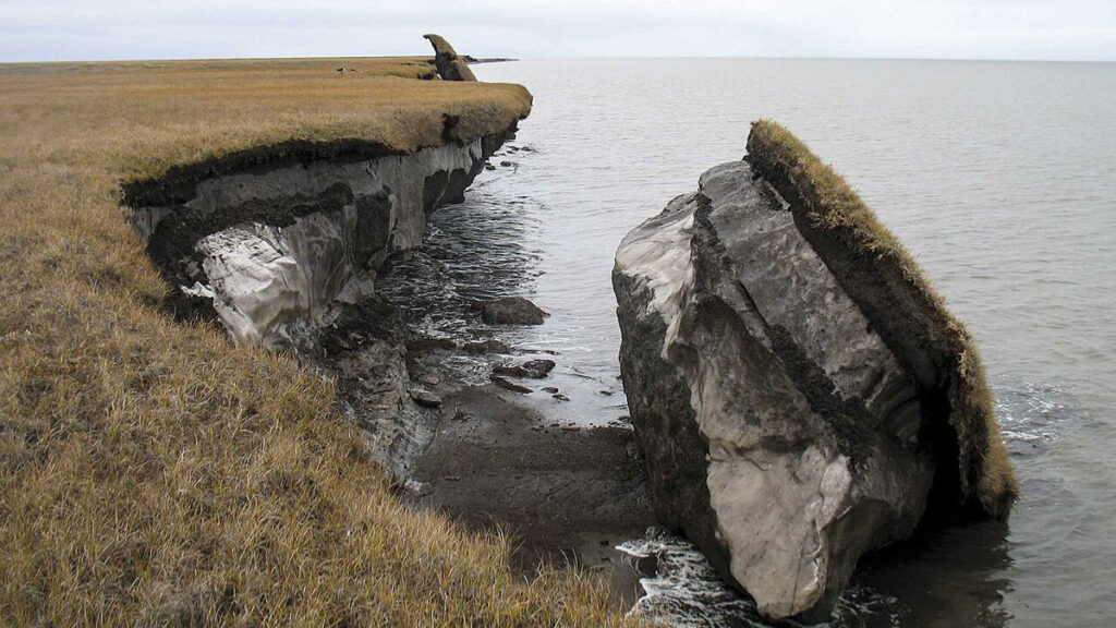 A piece of permafrost soil falling into the ocean in Alaska