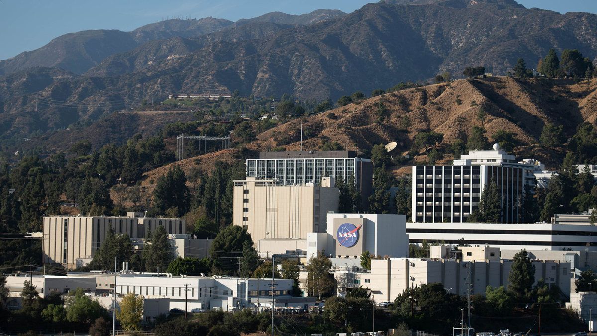 The JPL campus with mountains in the background. The NASA logo is prominently displayed.