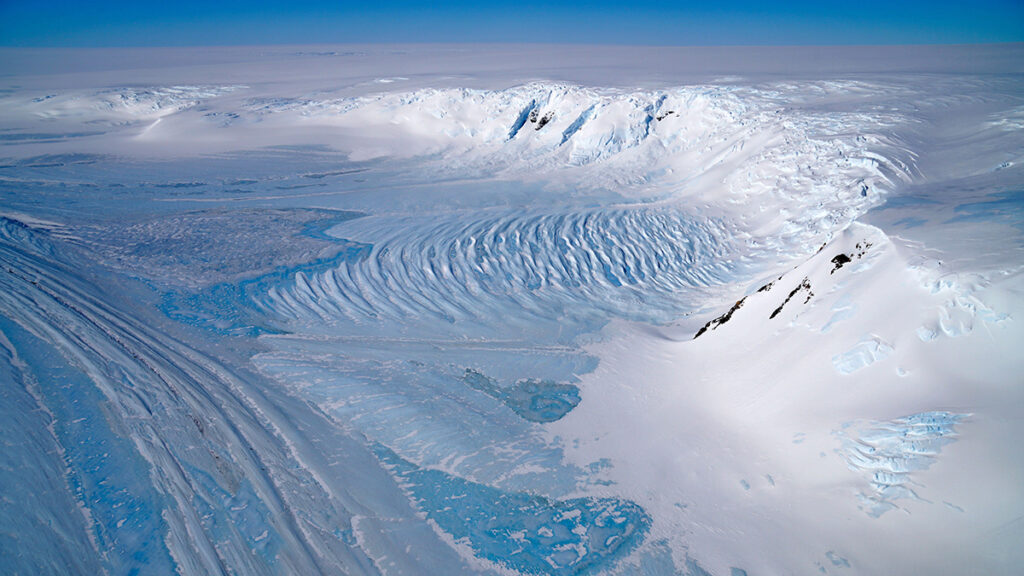 Aerial view of a wide blue ice area in the Transantarctic Mountains, where ancient Antarctic ice cores or fragments can be found for climate research