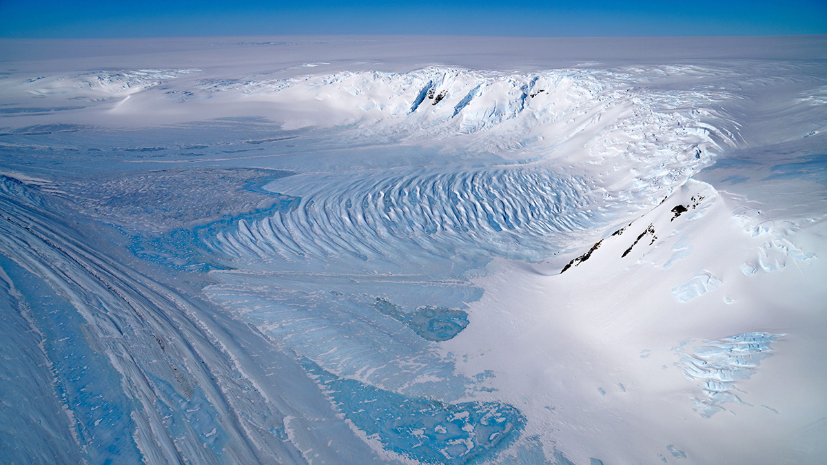 Aerial view of a wide blue ice area in the Transantarctic Mountains, where ancient Antarctic ice cores or fragments can be found for climate research
