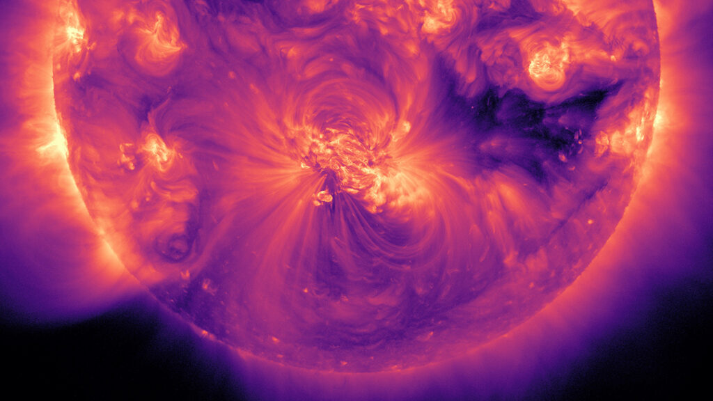 A view of the Sun as it appears in extreme ultraviolet light, with the light shown in shades of purple, pink, and orange