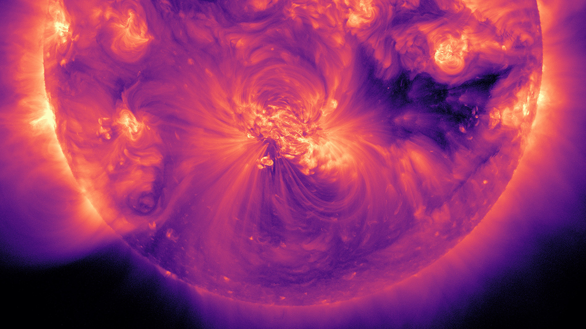A view of the Sun as it appears in extreme ultraviolet light, with the light shown in shades of purple, pink, and orange