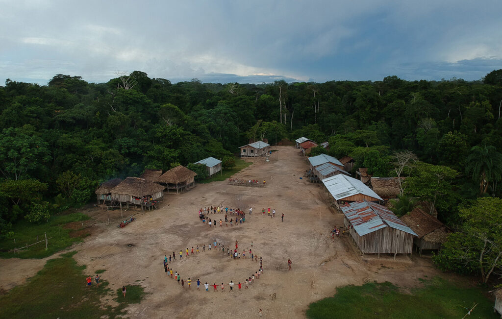 Aerial image of an Indigenous village deep in the Amazon rainforest