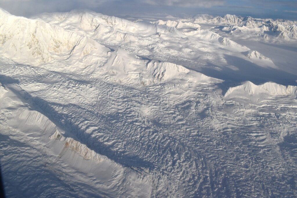 Widespread collapse of seracs and snow bridges on the south side of Mt Queen Mary. The field of view mid-photo is approximately 5 km across.
