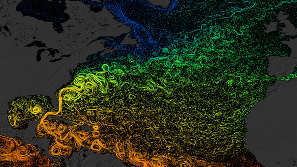 A colorized image of the North Atlantic Ocean shows swirls of (from top to bottom) blue, green, yellow, and orange.