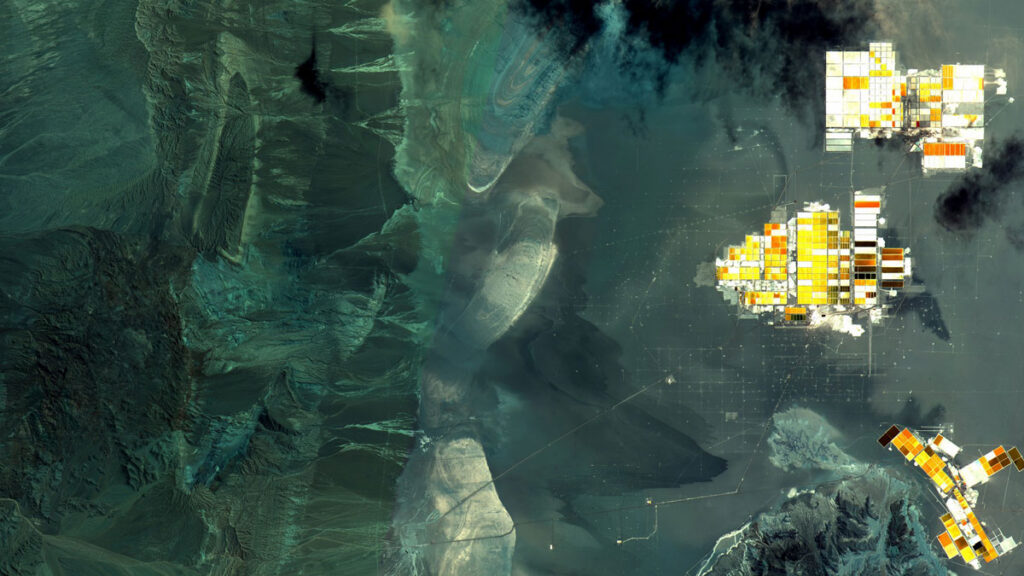 A landscape seen from overhead appears to be mostly bluish. At right, a series of white, orange, red, and brown rectangles are connected into loose shapes.