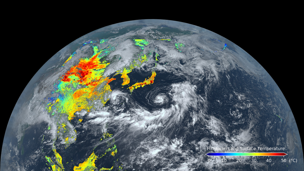 Satellite view of half of Earth against a black background showing parts of East Asia and Oceania; it has land surface temperature data, represented on a blue (cold) to red (hot) rainbow color scale, superimposed on it.