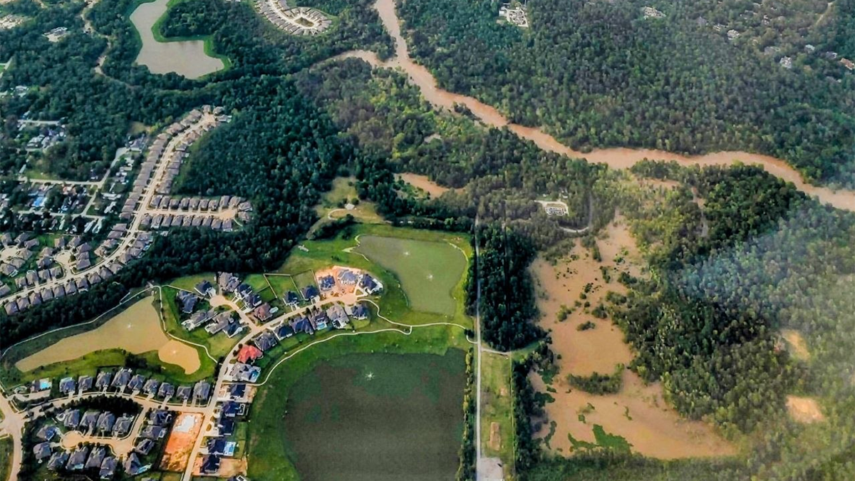 Aerial view of a flooded landscape and town.