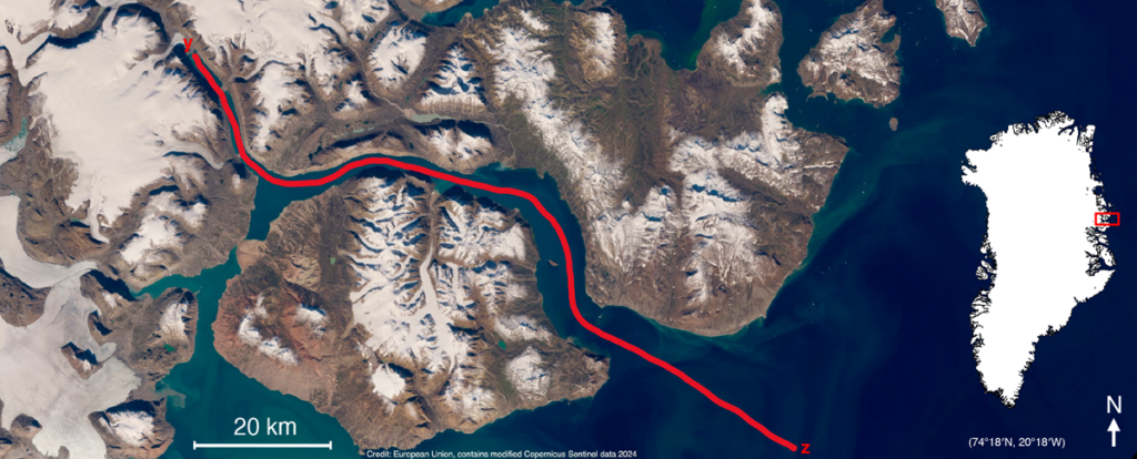 Satellite view over the glaciated islands and land of part of the northeastern Greenland coast. A red line maps the route of an August 2023 research cruise, and an inset map shows the location within Greenland.