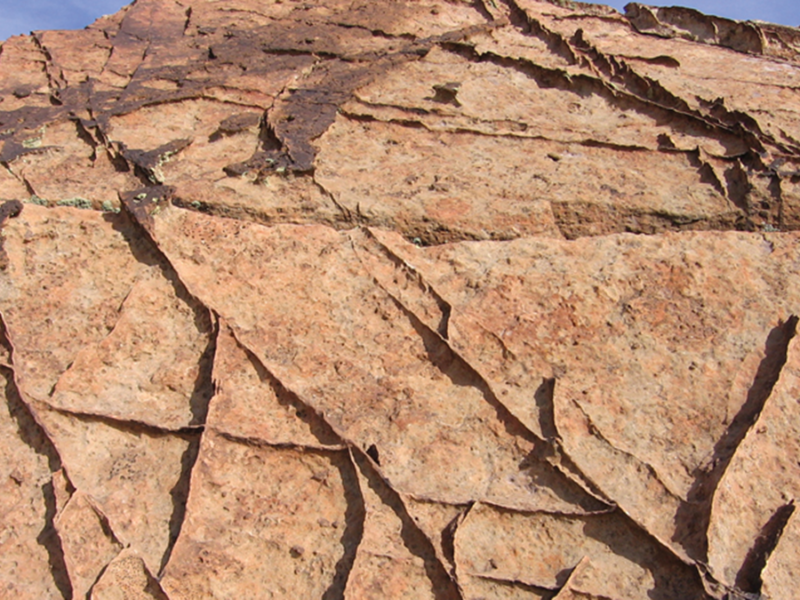 From Grains to Bands: Modeling Deformation in Porous Rocks