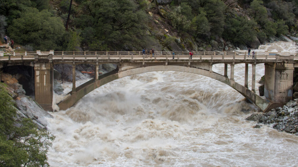 The flooded Yuba River rages underneath the Highway 49 Bridge in Nevada City, Calif.