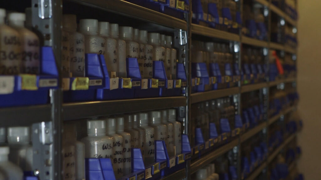 Shelves filled with labeled environmental samples in long-term storage.