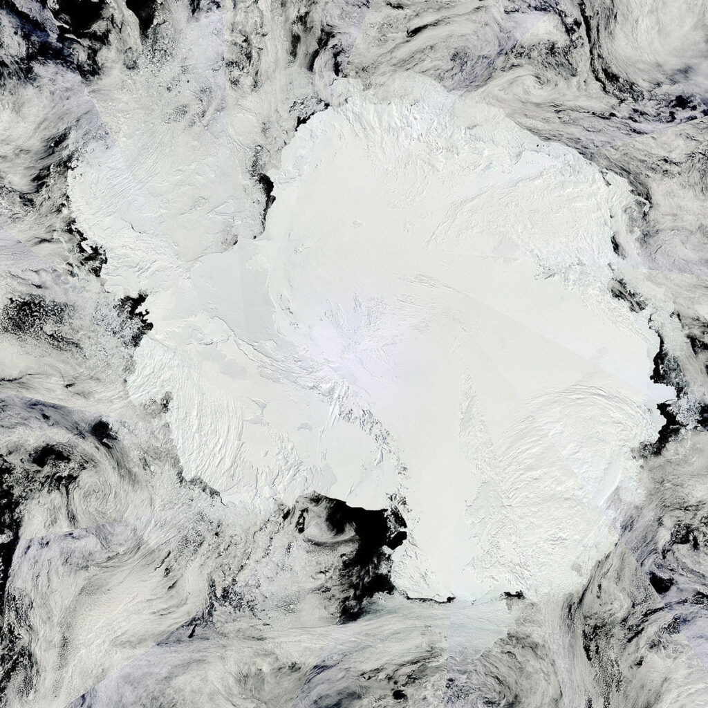 A mosaic of satellite images shows the Antarctic continent under clouds.