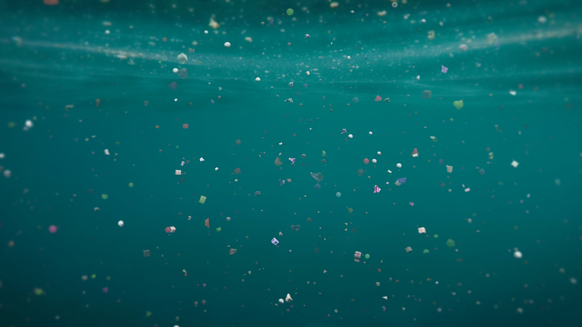 Small bits of plastic float below the ocean surface in an artist’s rendering.