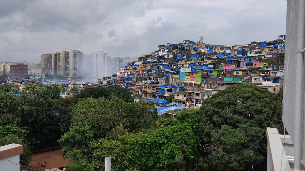 View of a city: Tall buildings and colorful makeshift structures make up the skyline of Mumbai.