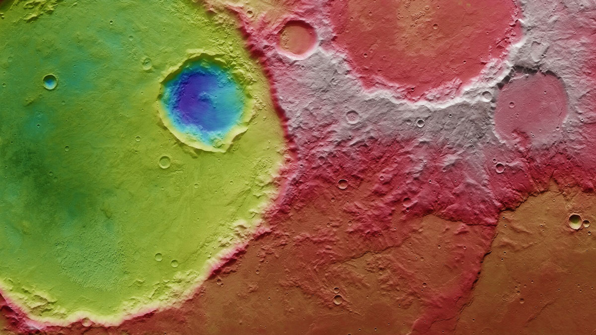 One large crater, containing a subcrater, and several smaller craters, speckle a portion of Mars’s surface.