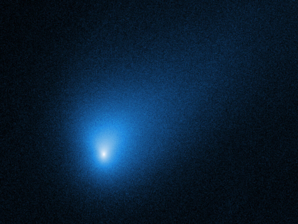 A blueish comet with a tail on a black background
