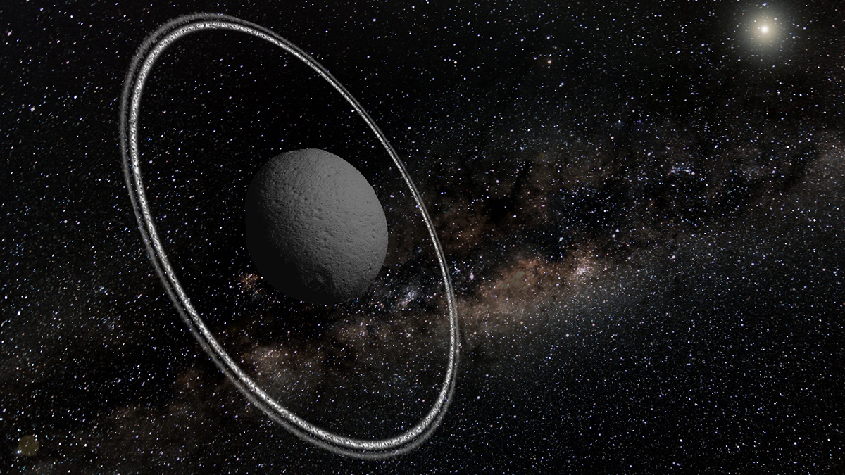 Illustration of a gray asteroid with two sharp rings seen at an angle. The Sun shines in the distance, and the Milky Way decorates the background.